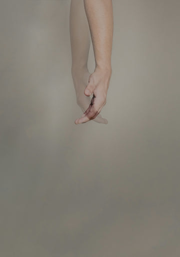 person's hand with pink manicure