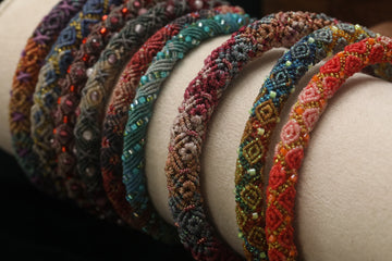 A collection of colorful beaded bracelets arranged in a row.